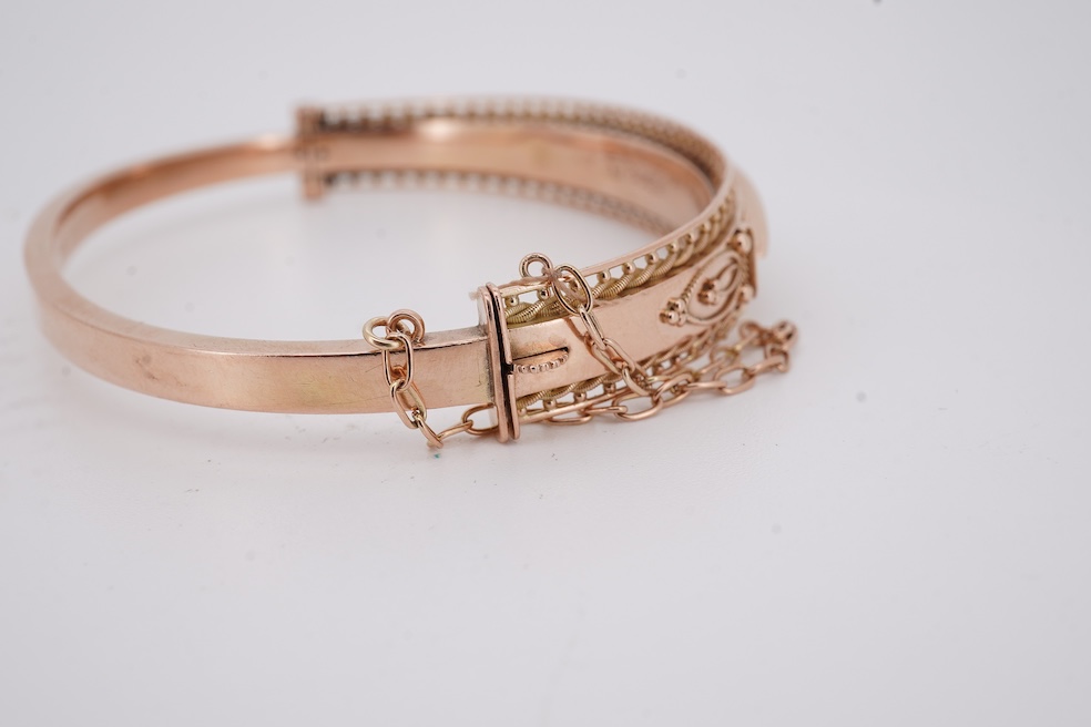 An Edwardian 9ct gold, sapphire and diamond set hinged bangle, Chester, 1909, interior diameter 57mm, gross weight 10 grams. Condition - poor